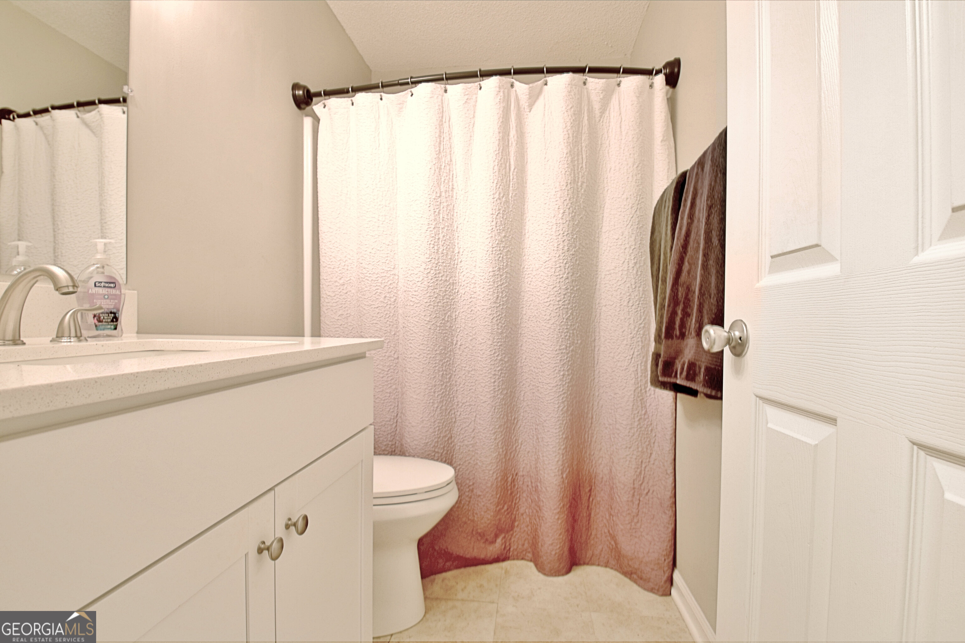 104 Blue Ridge Drive Newnan, GA 30265 - Photo 44 of 60 a bathroom with a sink a toilet and shower curtain