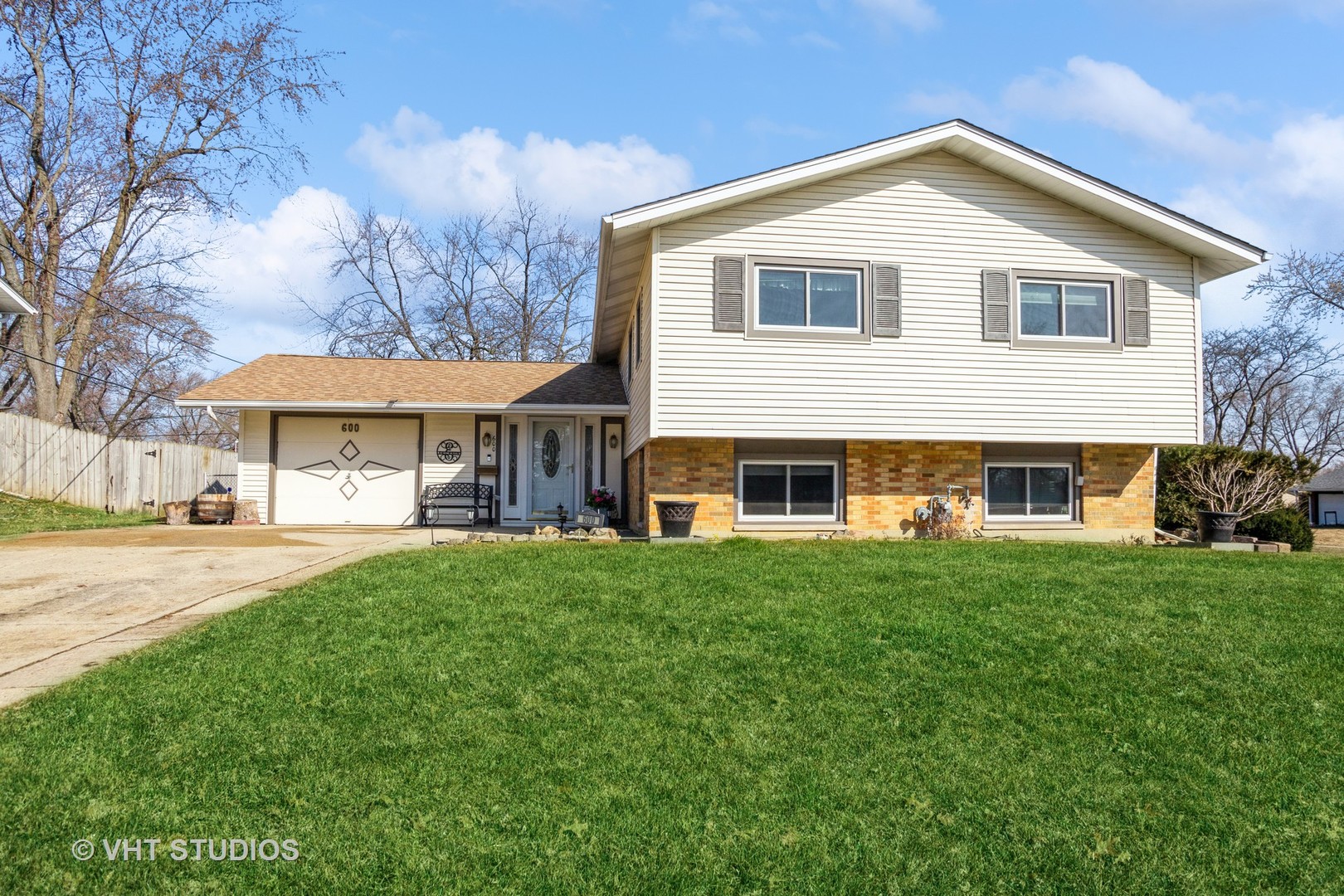 a front view of a house with a garden