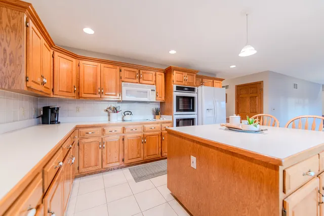 a bathroom with a toilet a sink a mirror a vanity and shower