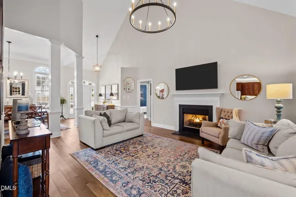 a living room with furniture a fireplace and a flat screen tv
