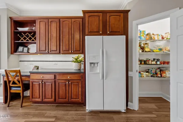 a kitchen with stainless steel appliances granite countertop a refrigerator and a stove top oven