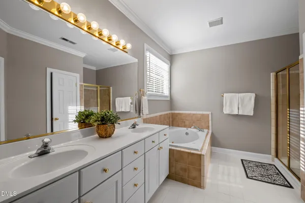 a bathroom with a sink double vanity granite and a mirror