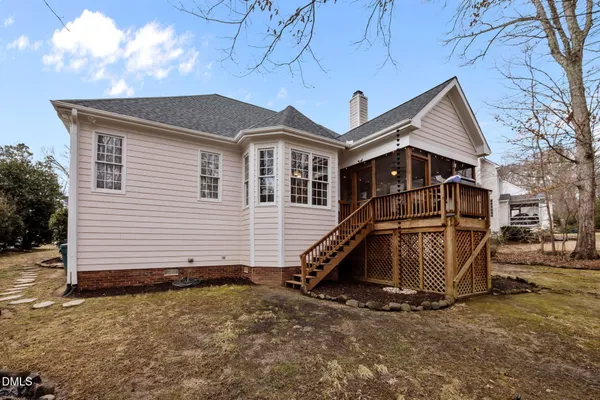 a view of a house with wooden fence