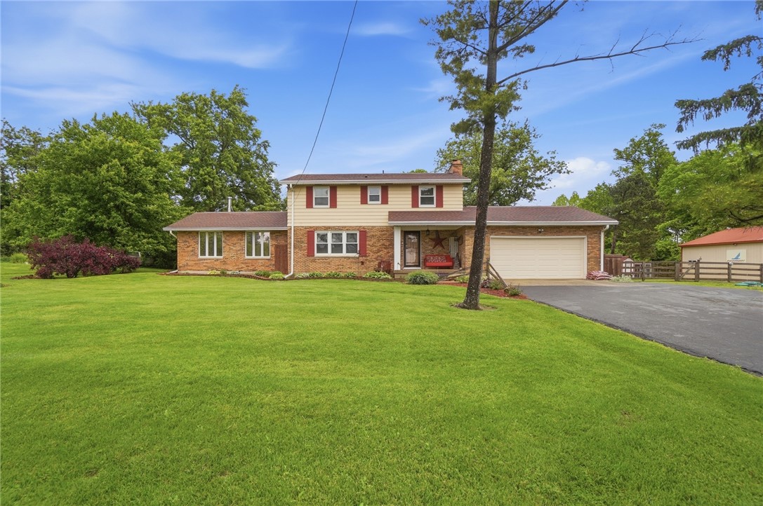 4170 Johnson Road Springfield, OH 45502 - Photo 2 of 54 A classic brick and siding home features an attached garage and a vast, well-maintained lawn.