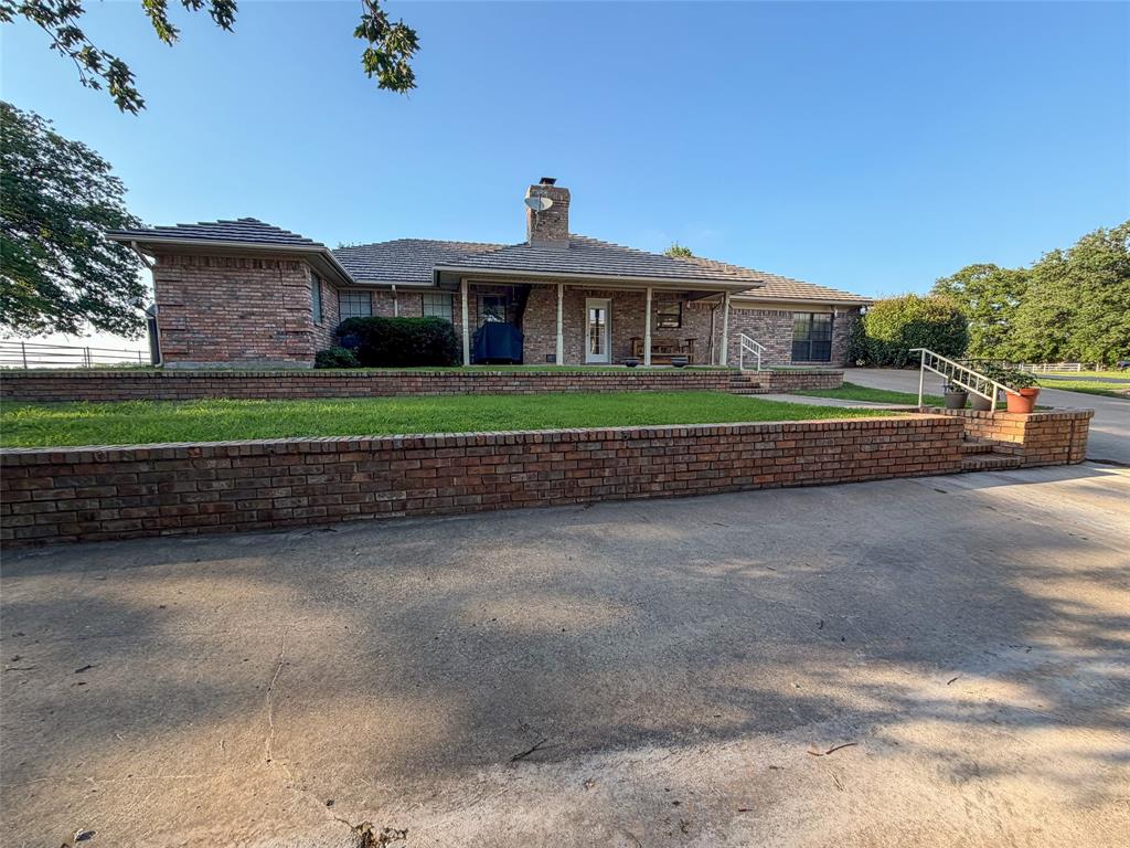 449 Private Road 4670 Rhome, TX 76078 - Photo 17 of 39 a front view of a house with a yard