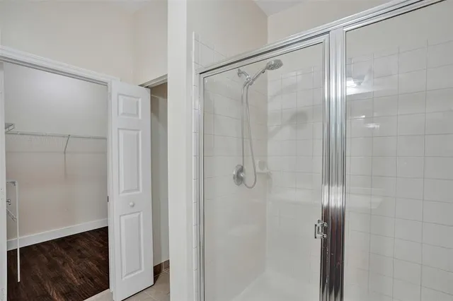 an empty room with wooden floor and window