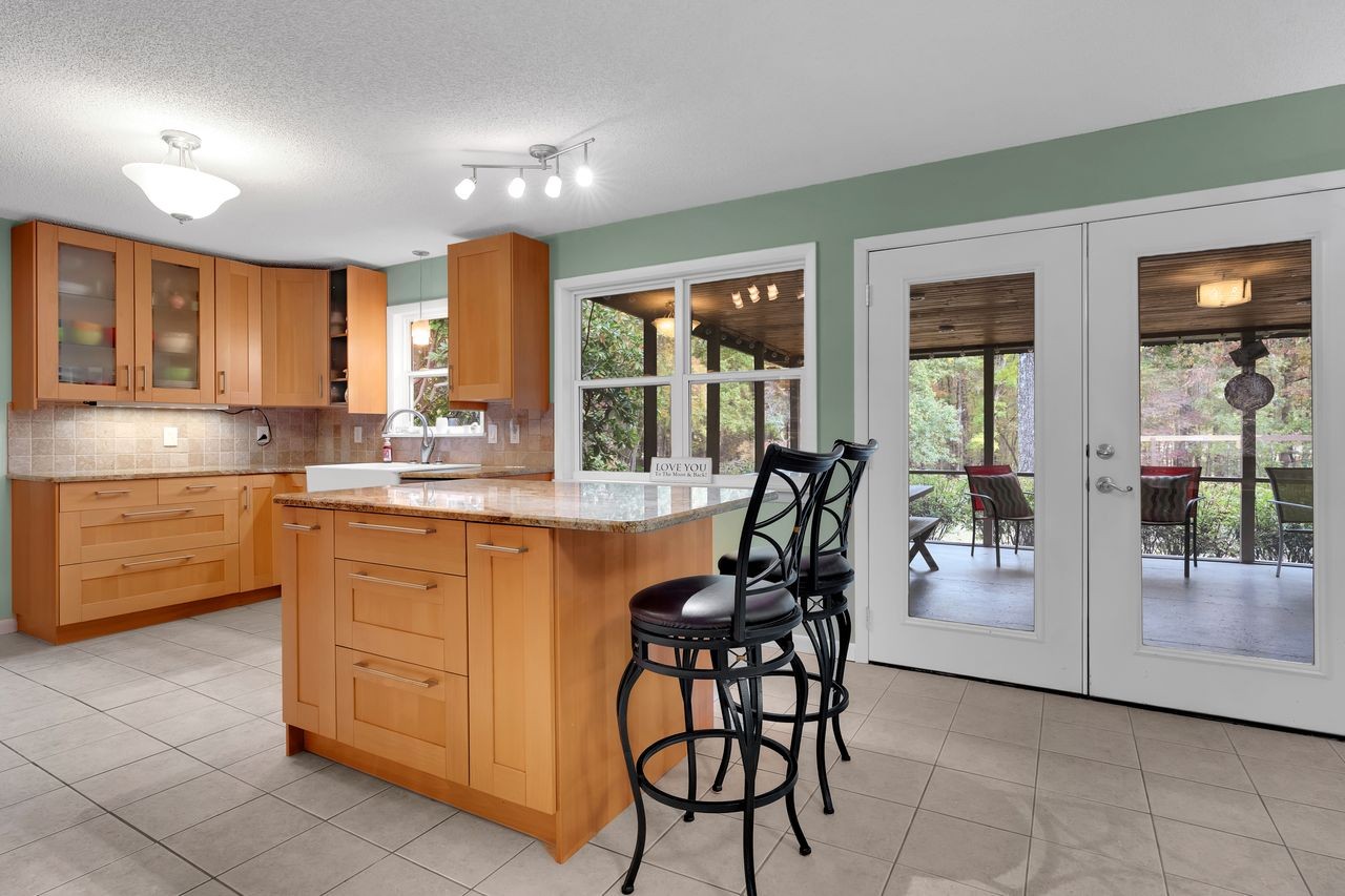 3711 Jumpoff Road Sewanee, TN 37375 - Photo 13 of 57 a kitchen with stainless steel appliances kitchen island granite countertop a stove a sink and a microwave