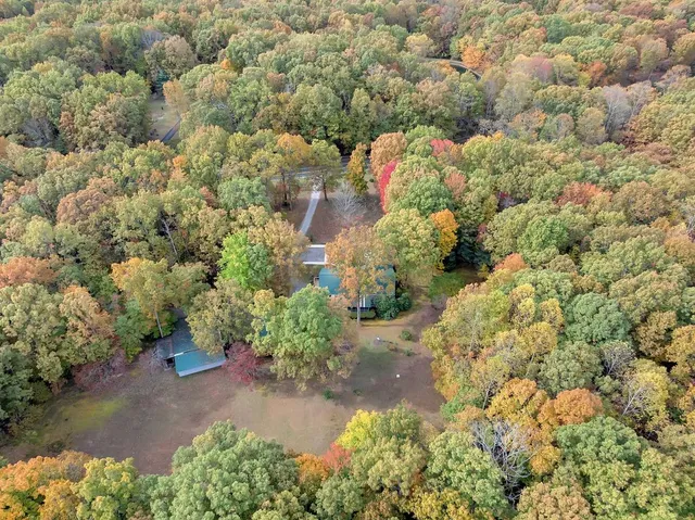 a living room with furniture a flat screen tv and a large window