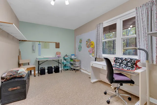 a work room with furniture and a wooden floor