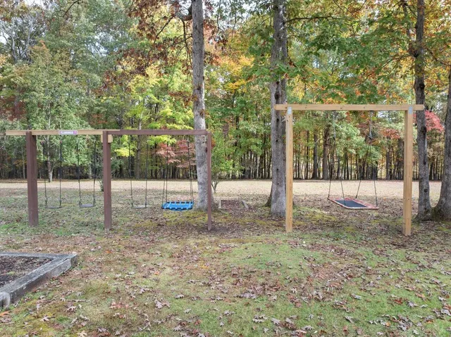 a view of a backyard with large trees