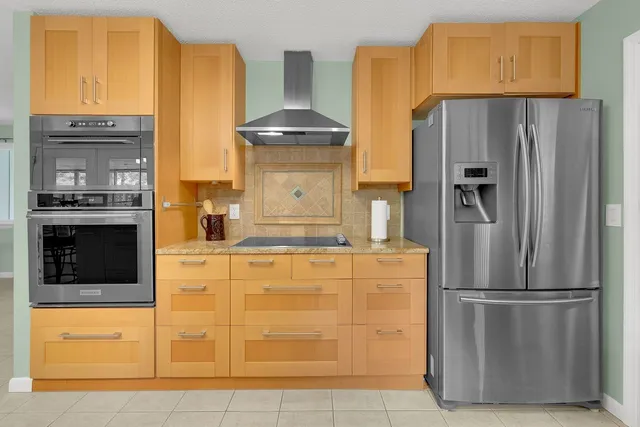 a kitchen with stainless steel appliances kitchen island granite countertop a stove a sink and a microwave