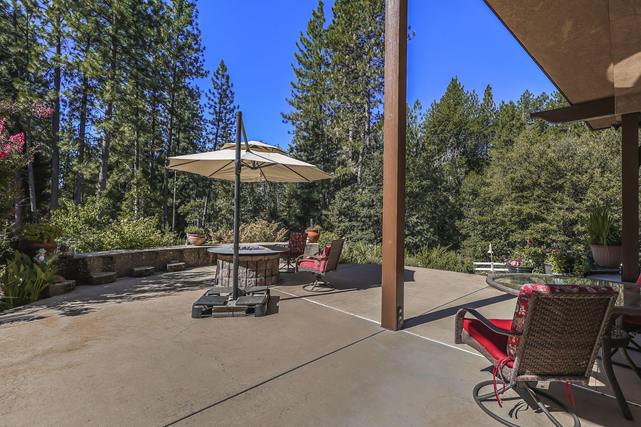 14703 Fern Road Whitmore, CA 96096 - Photo 29 of 48 a view of a patio with a table and chairs under an umbrella