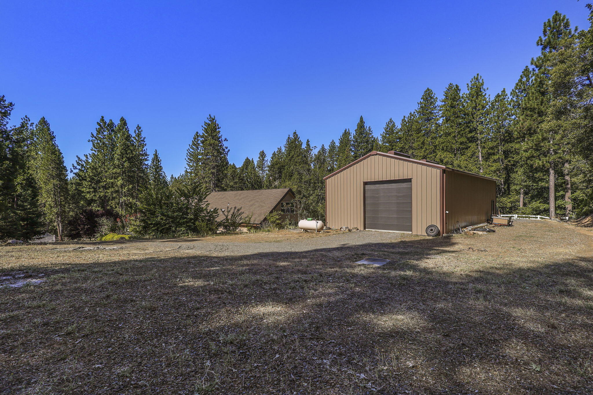 14703 Fern Road Whitmore, CA 96096 - Photo 34 of 48 a backyard of a house with lots of green space and outdoor seating