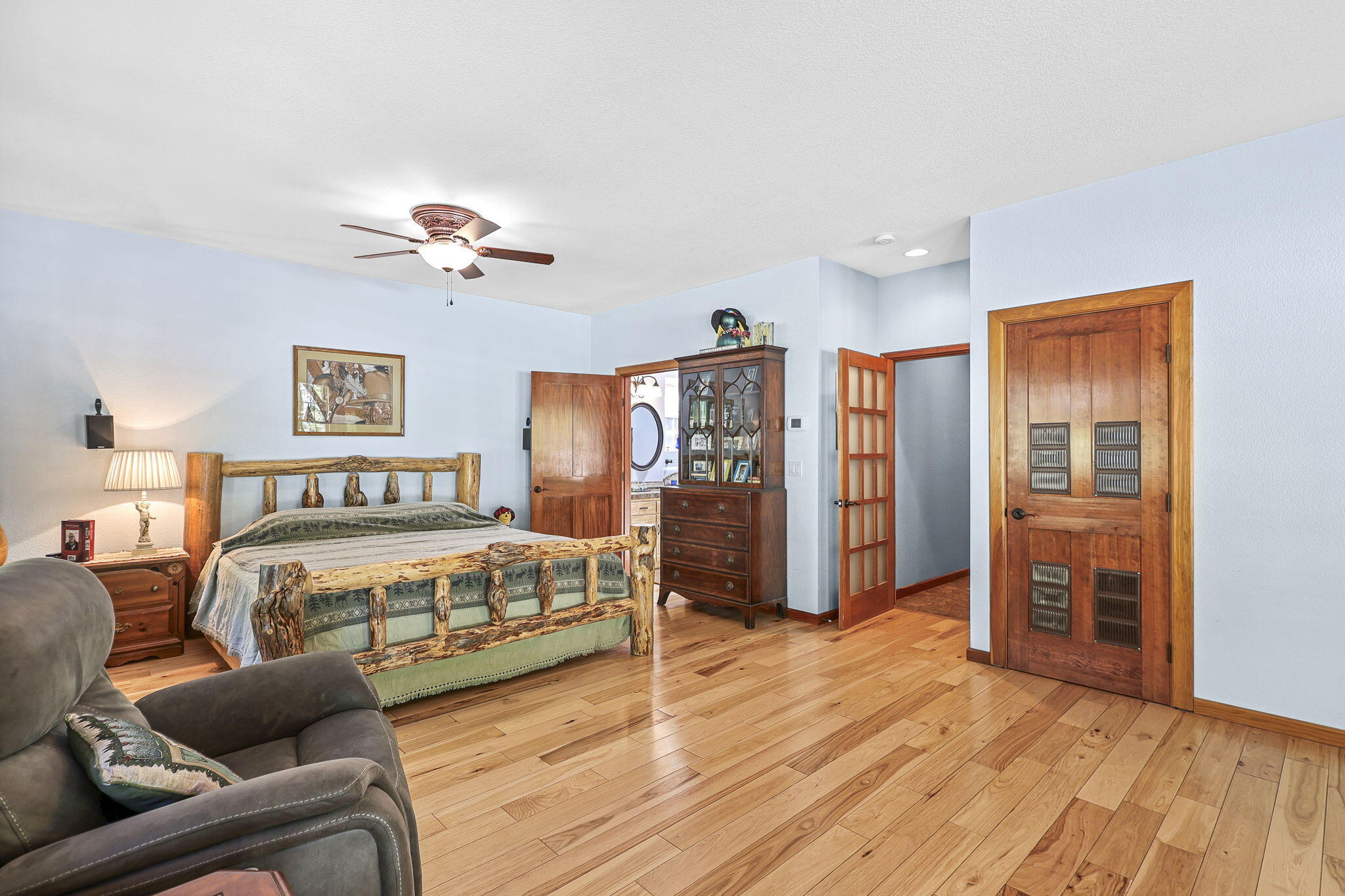 14703 Fern Road Whitmore, CA 96096 - Photo 45 of 48 a spacious bedroom with a bed a couch and a dresser