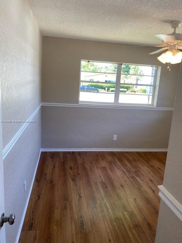2060 Northeast 26th Street Lighthouse Point, FL 33064 - Photo 11 of 24 wooden floor in an empty room with a window