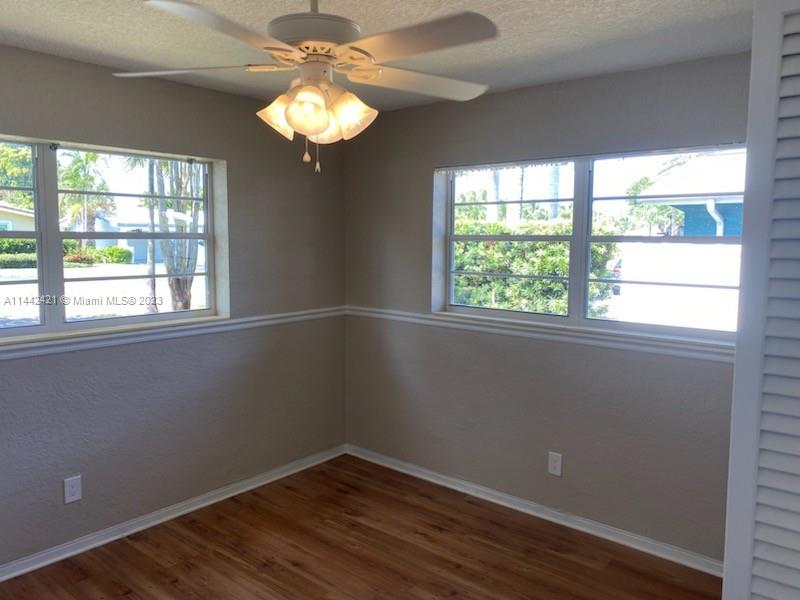 2060 Northeast 26th Street Lighthouse Point, FL 33064 - Photo 12 of 24 wooden floor in an empty room with a window