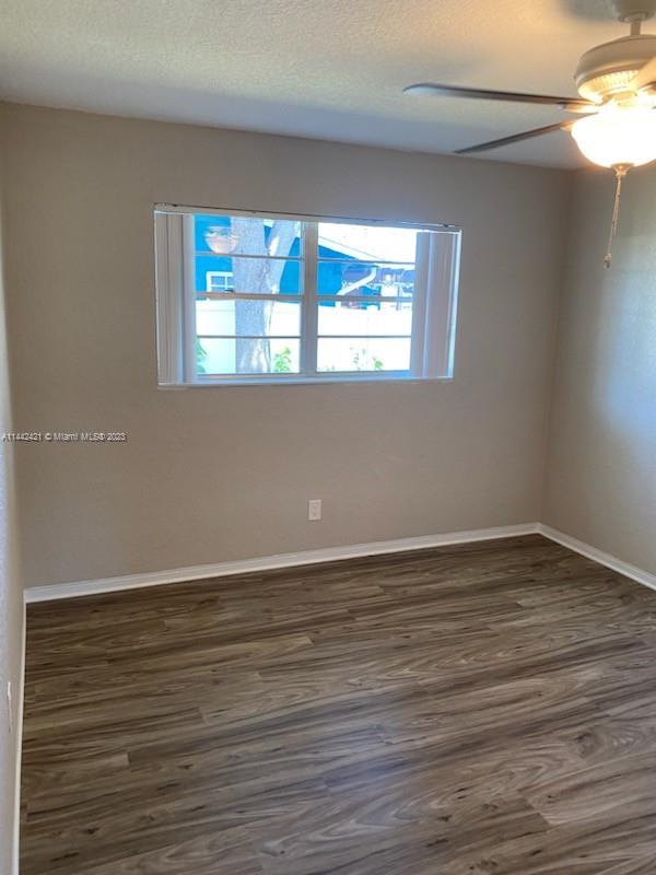 2060 Northeast 26th Street Lighthouse Point, FL 33064 - Photo 13 of 24 a view of an empty room with wooden floor and a window