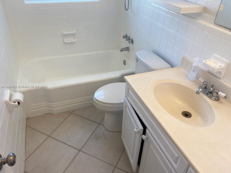 2060 Northeast 26th Street Lighthouse Point, FL 33064 - Photo 15 of 24 a bathroom with a sink a toilet and bathtub
