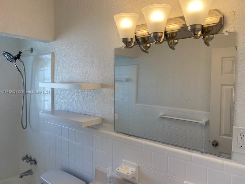 2060 Northeast 26th Street Lighthouse Point, FL 33064 - Photo 16 of 24 a bathroom with a shower and a mirror