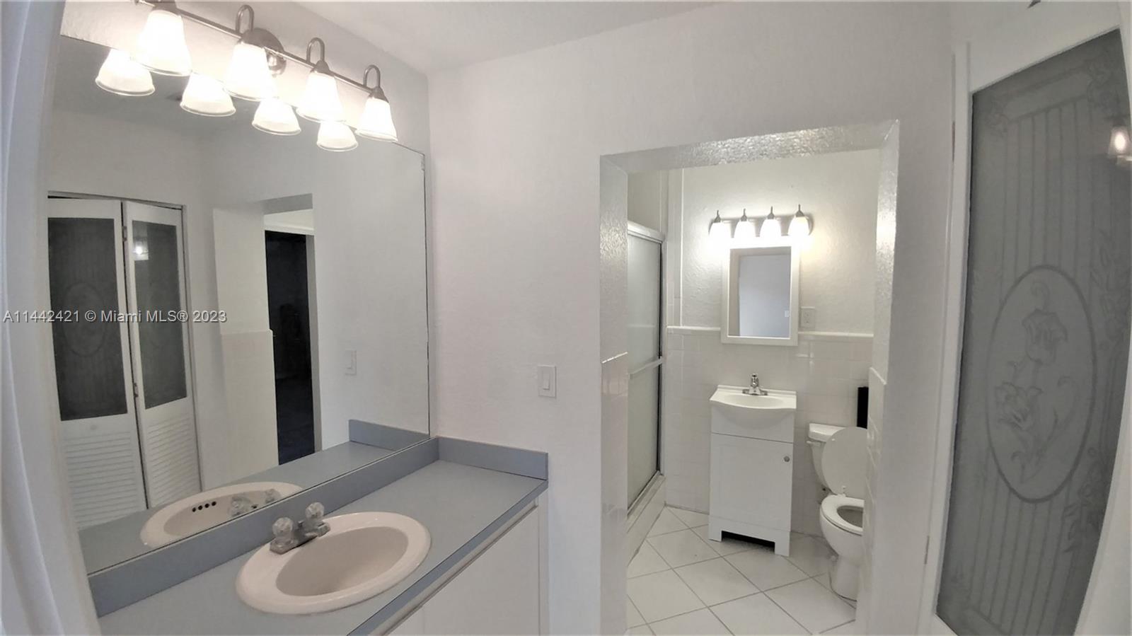 2060 Northeast 26th Street Lighthouse Point, FL 33064 - Photo 19 of 24 a bathroom with a sink a toilet and shower