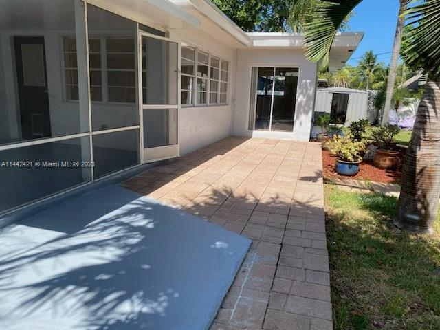 2060 Northeast 26th Street Lighthouse Point, FL 33064 - Photo 24 of 24 a view of backyard with large window and potted plants
