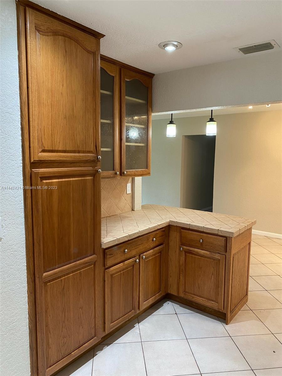 2060 Northeast 26th Street Lighthouse Point, FL 33064 - Photo 6 of 24 a kitchen with stainless steel appliances granite countertop a refrigerator and cabinets