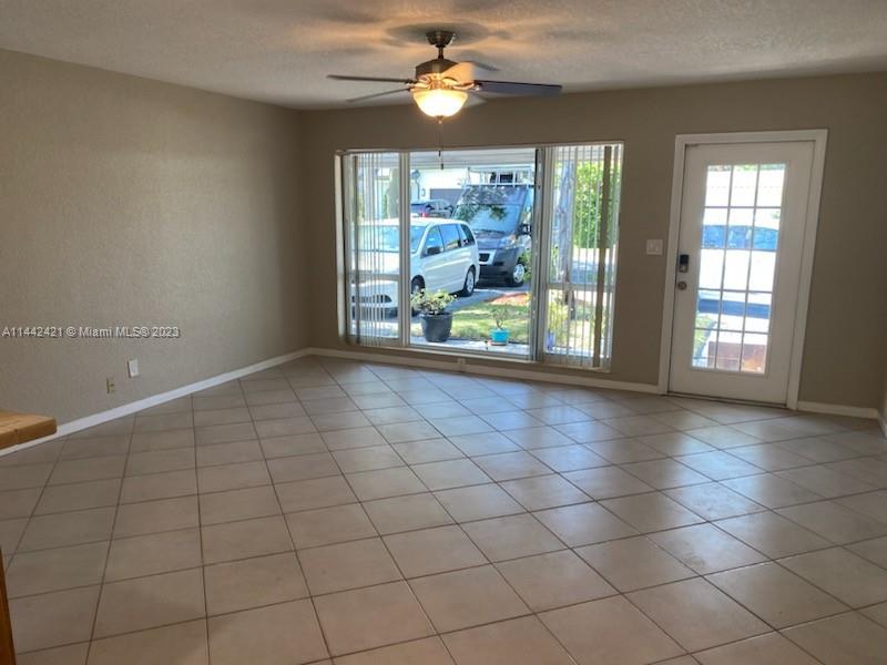 2060 Northeast 26th Street Lighthouse Point, FL 33064 - Photo 8 of 24 an empty room with windows and ceiling fan
