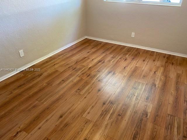 2060 Northeast 26th Street Lighthouse Point, FL 33064 - Photo 10 of 24 a view of room with wooden floor