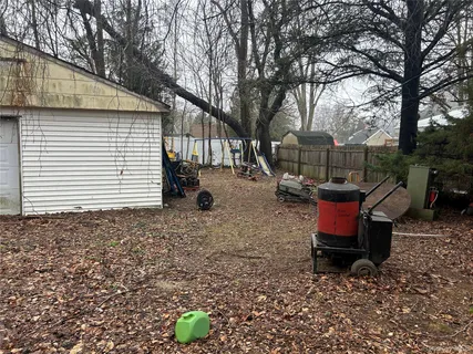 a backyard of a house with barbeque oven fire pit table and chairs