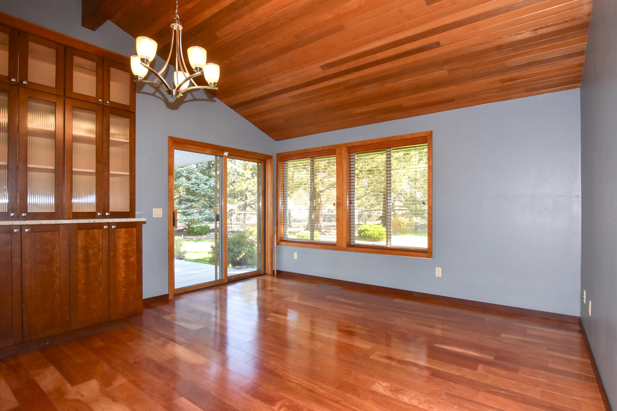 64730 Sylvan Loop Bend, OR 97701 - Photo 19 of 46 a view of an empty room with wooden floor and a window