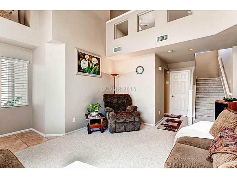 936 Midpride Street Las Vegas, NV 89144 - Photo 5 of 33 Living Room. Landing above with glass windows