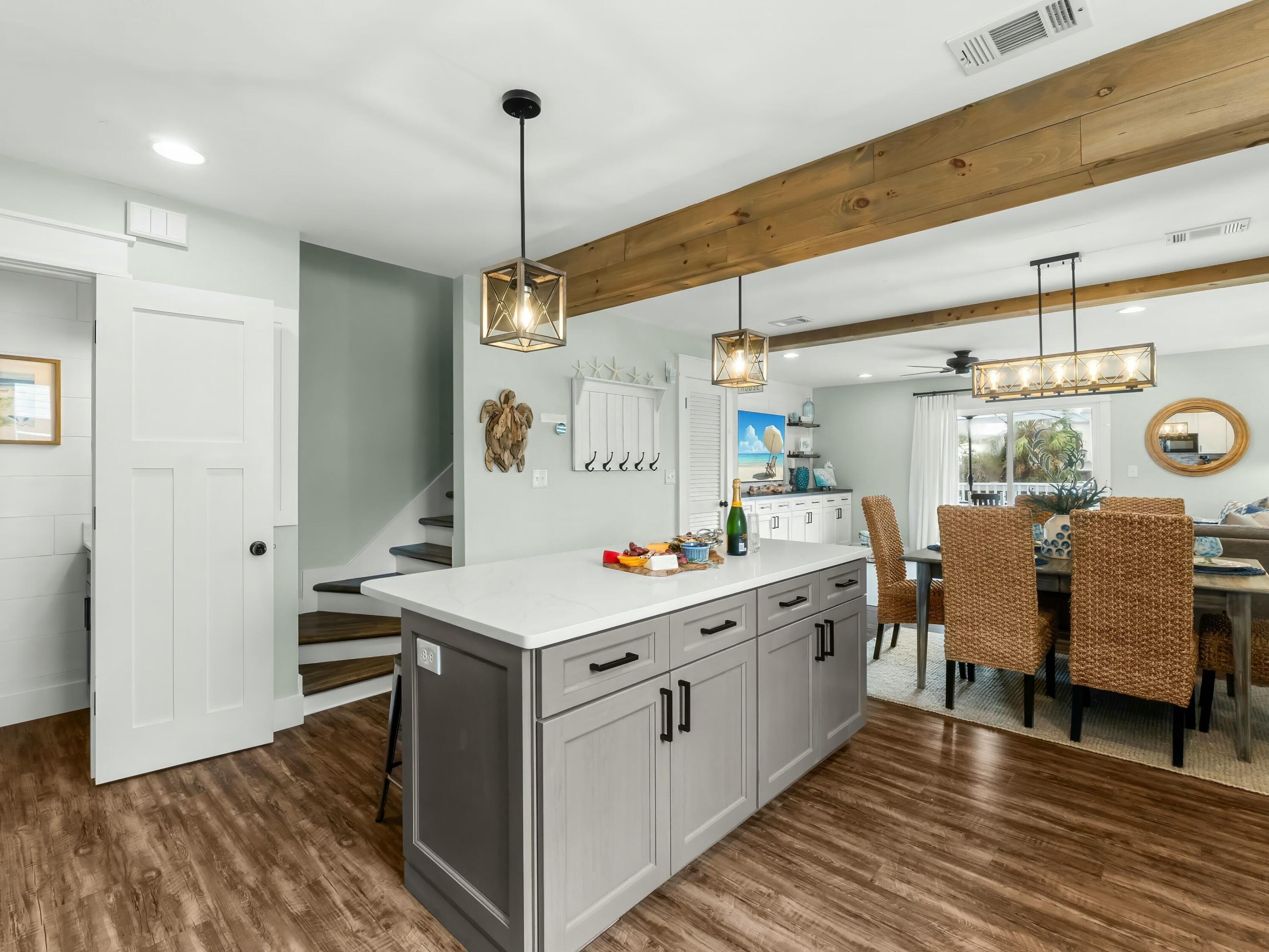 229 Blue Mountain Road, Unit 103 Santa Rosa Beach, FL 32459 - Photo 7 of 50 a kitchen that has a lot of cabinets in it and wooden floor