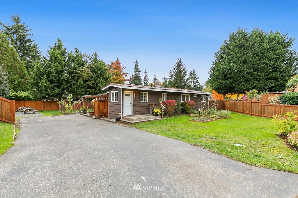 631 219th Place Southwest Bothell, WA 98021 - Photo 2 of 21 a front view of a house with a yard and trees