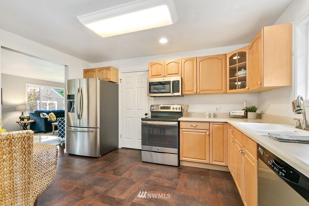 631 219th Place Southwest Bothell, WA 98021 - Photo 7 of 21 a kitchen with refrigerator and cabinets