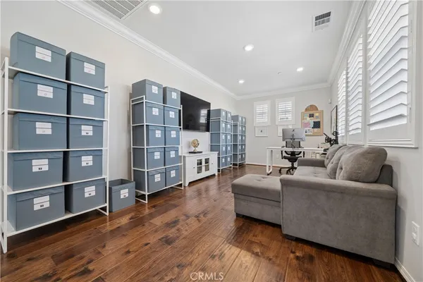 a living room with furniture and a book shelf