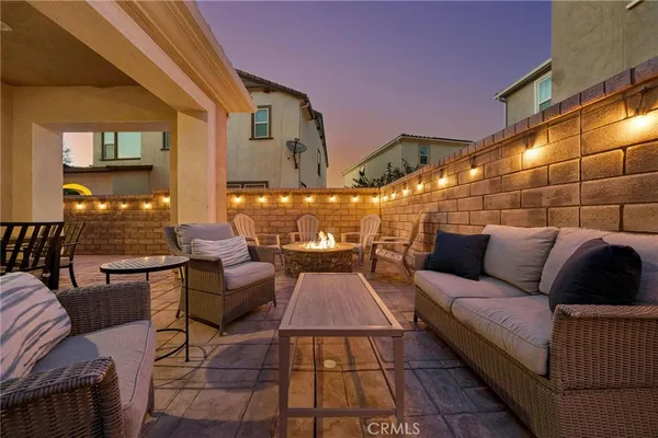 a outdoor living space with furniture and a fireplace