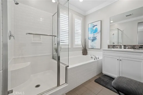 a bathroom with a bathtub a shower a sink and a mirror