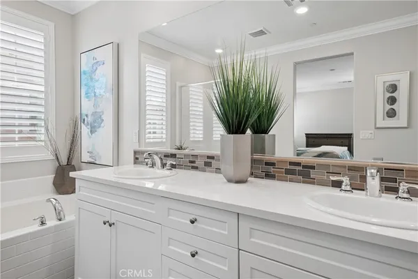 a bathroom with a double vanity sink and a bathtub