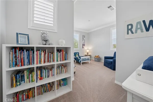 a living room with lots of books and a book shelf