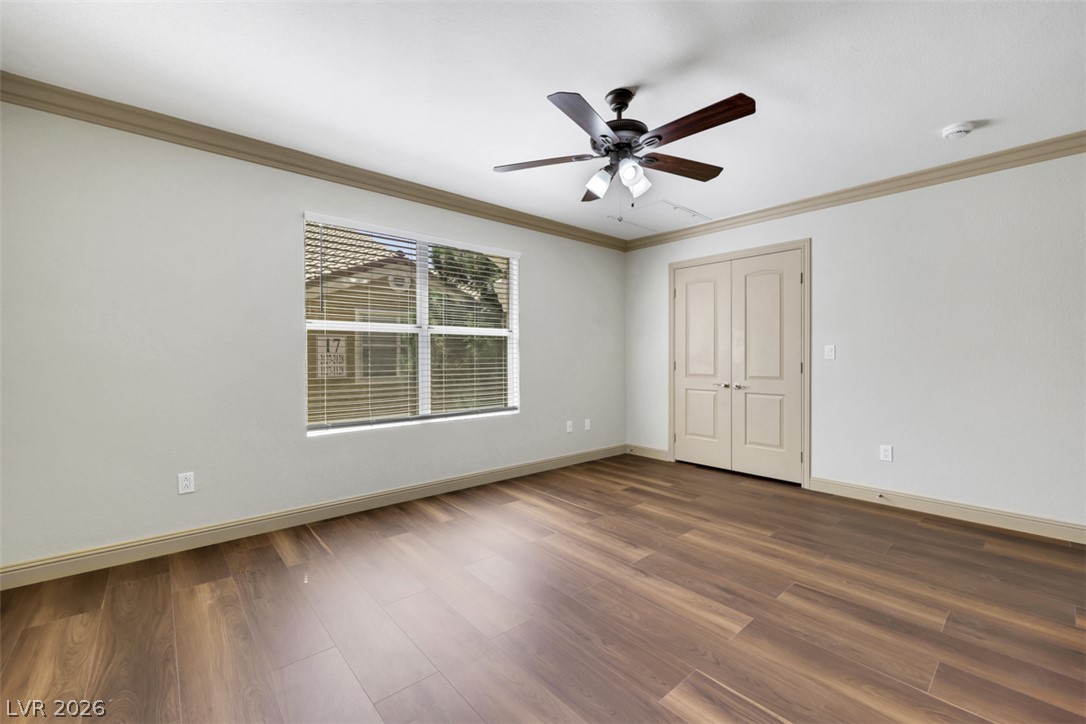 8101 West Flamingo Road, Unit 2136 Las Vegas, NV 89147 - Photo 21 of 32 Rich wood-look flooring and classic crown molding define this versatile interior space.