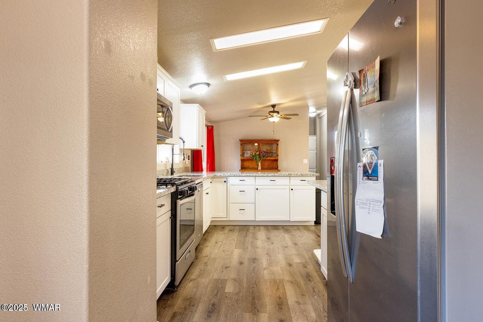 430 Timber Ridge Loop Show Low, AZ 85901 - Photo 11 of 27 a large white kitchen with cabinets and stainless steel appliances