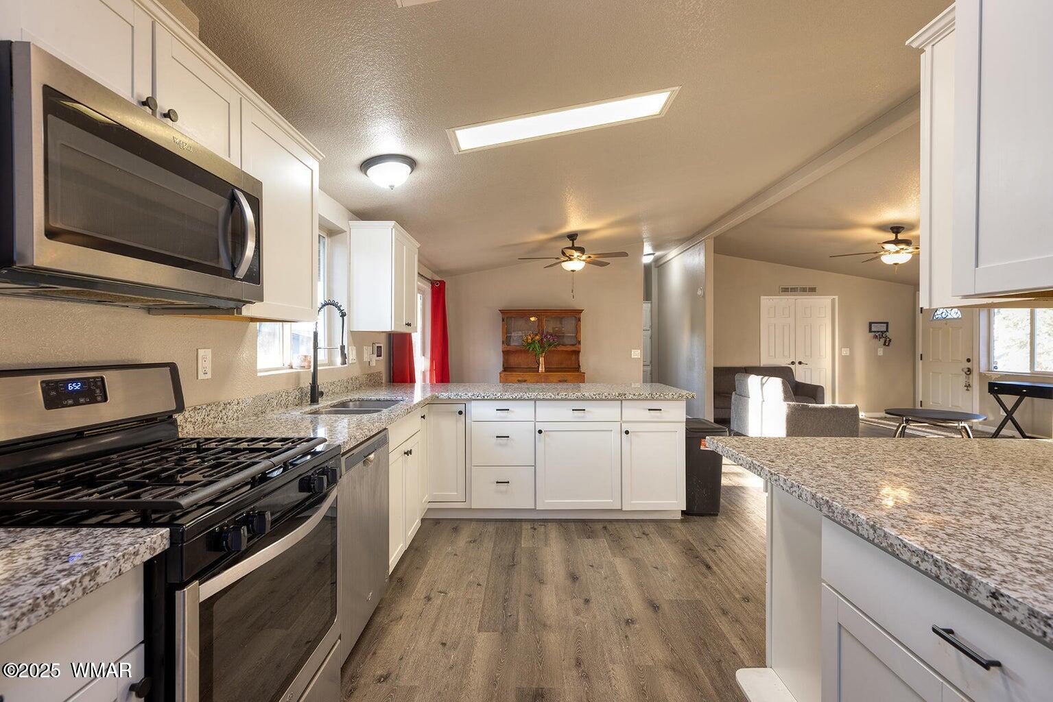 430 Timber Ridge Loop Show Low, AZ 85901 - Photo 12 of 27 a kitchen with a stove sink and microwave