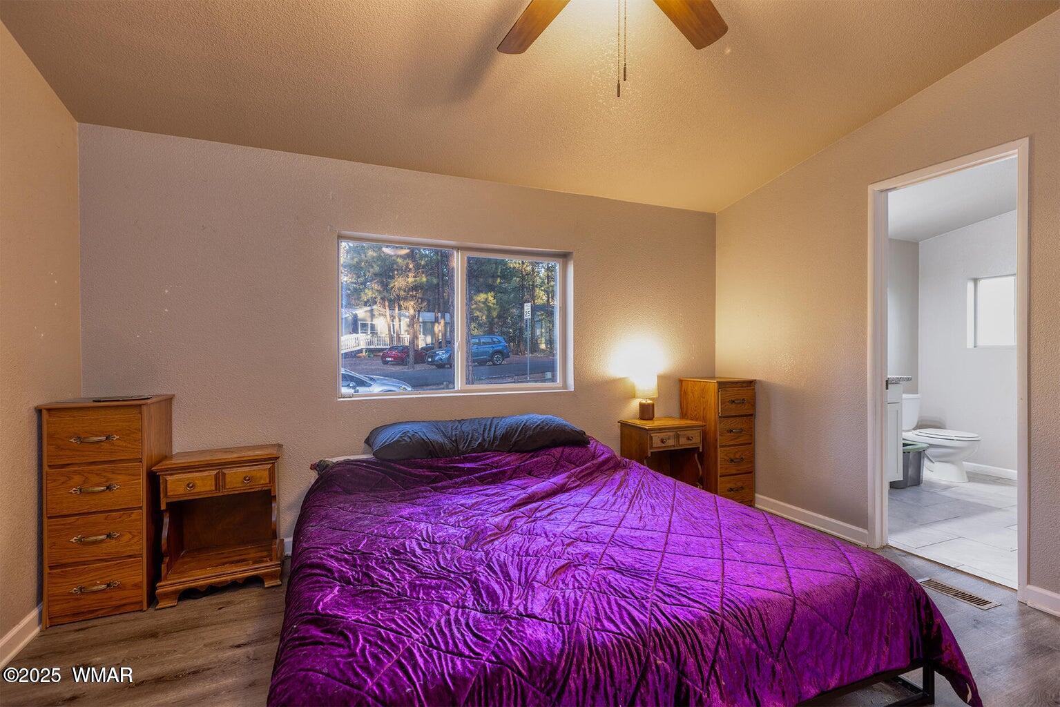 430 Timber Ridge Loop Show Low, AZ 85901 - Photo 14 of 27 a bedroom with a bed and a lamp