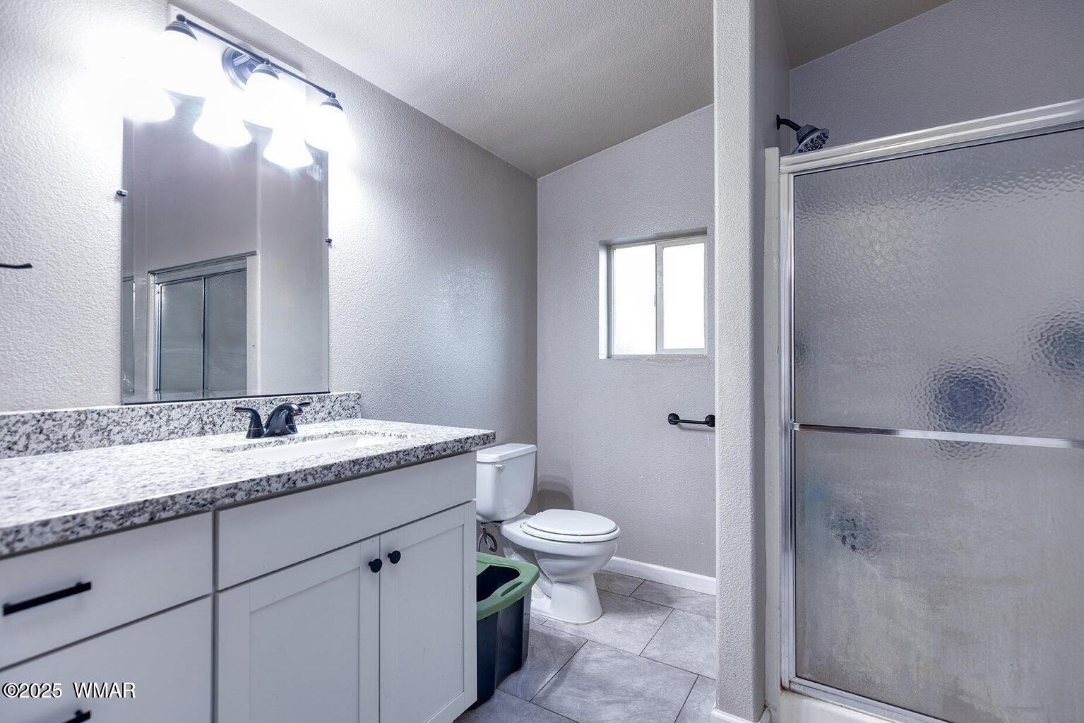 430 Timber Ridge Loop Show Low, AZ 85901 - Photo 15 of 27 a bathroom with a granite countertop sink toilet and shower