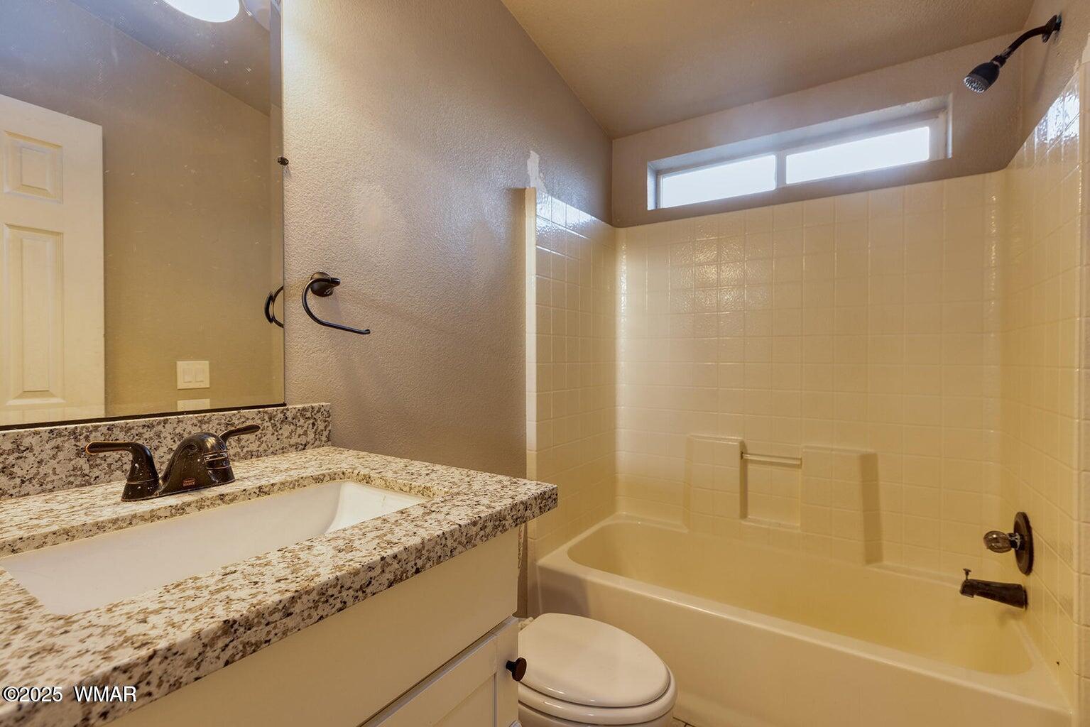 430 Timber Ridge Loop Show Low, AZ 85901 - Photo 20 of 27 a bathroom with a granite countertop sink toilet and shower