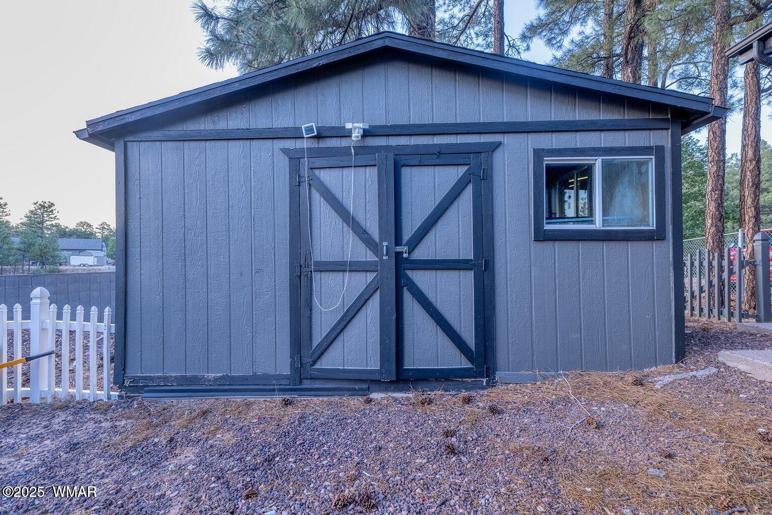 430 Timber Ridge Loop Show Low, AZ 85901 - Photo 21 of 27 a wooden door in front of a house