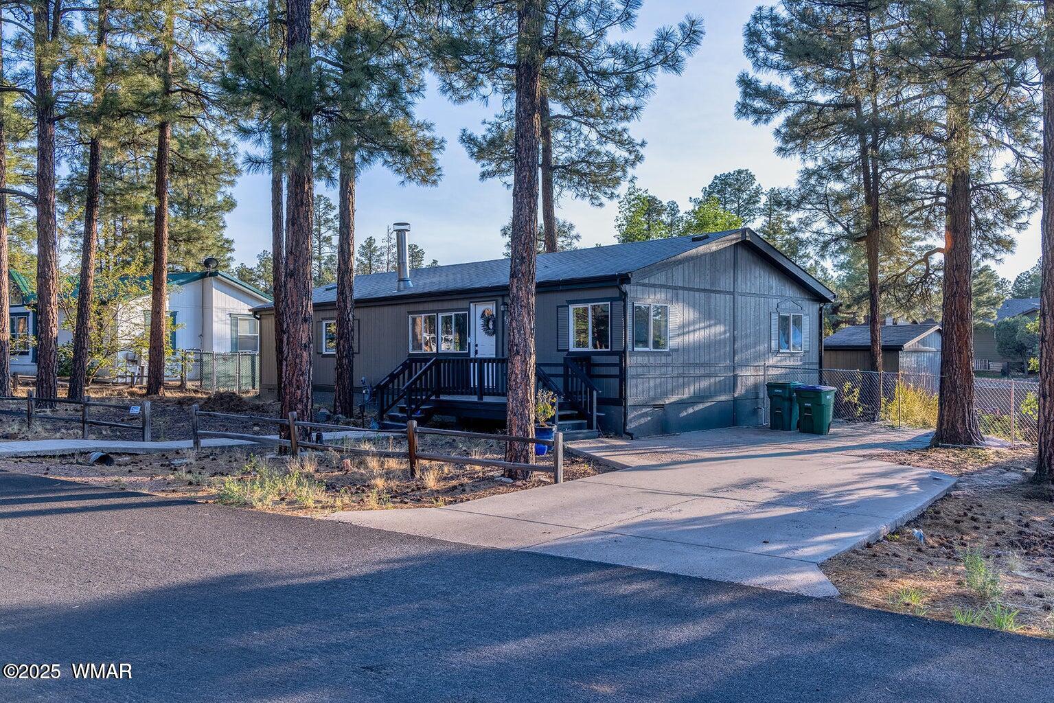 430 Timber Ridge Loop Show Low, AZ 85901 - Photo 25 of 27 a view of a house with backyard and trees