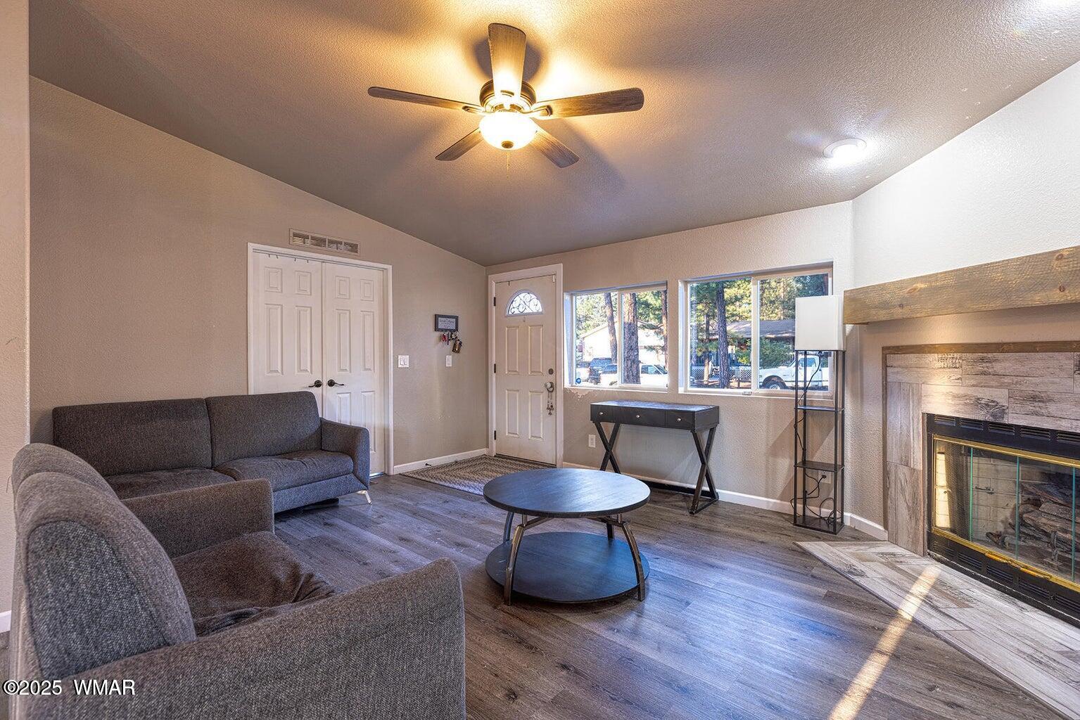 430 Timber Ridge Loop Show Low, AZ 85901 - Photo 3 of 27 a living room with furniture a fireplace and a table