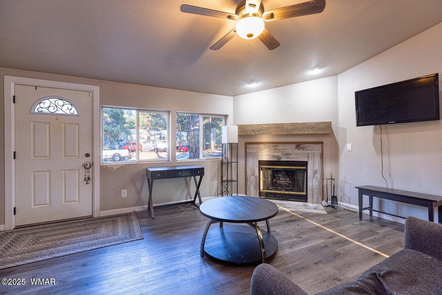 430 Timber Ridge Loop Show Low, AZ 85901 - Photo 5 of 27 a living room with furniture a fireplace and a flat screen tv