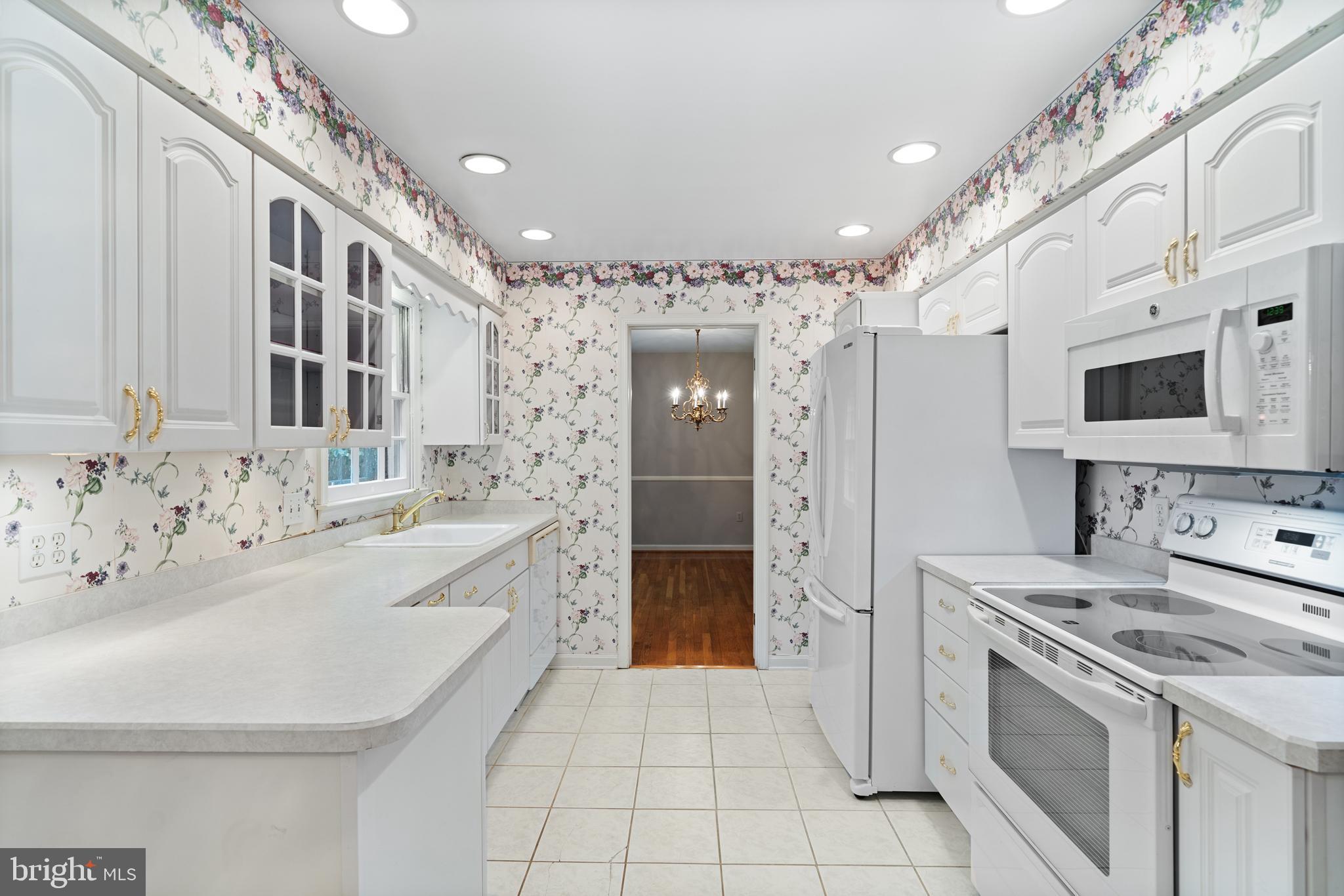 1643 Homewood Road Annapolis, MD 21409 - Photo 19 of 59 a large white kitchen with stainless steel appliances granite countertop a sink and a refrigerator
